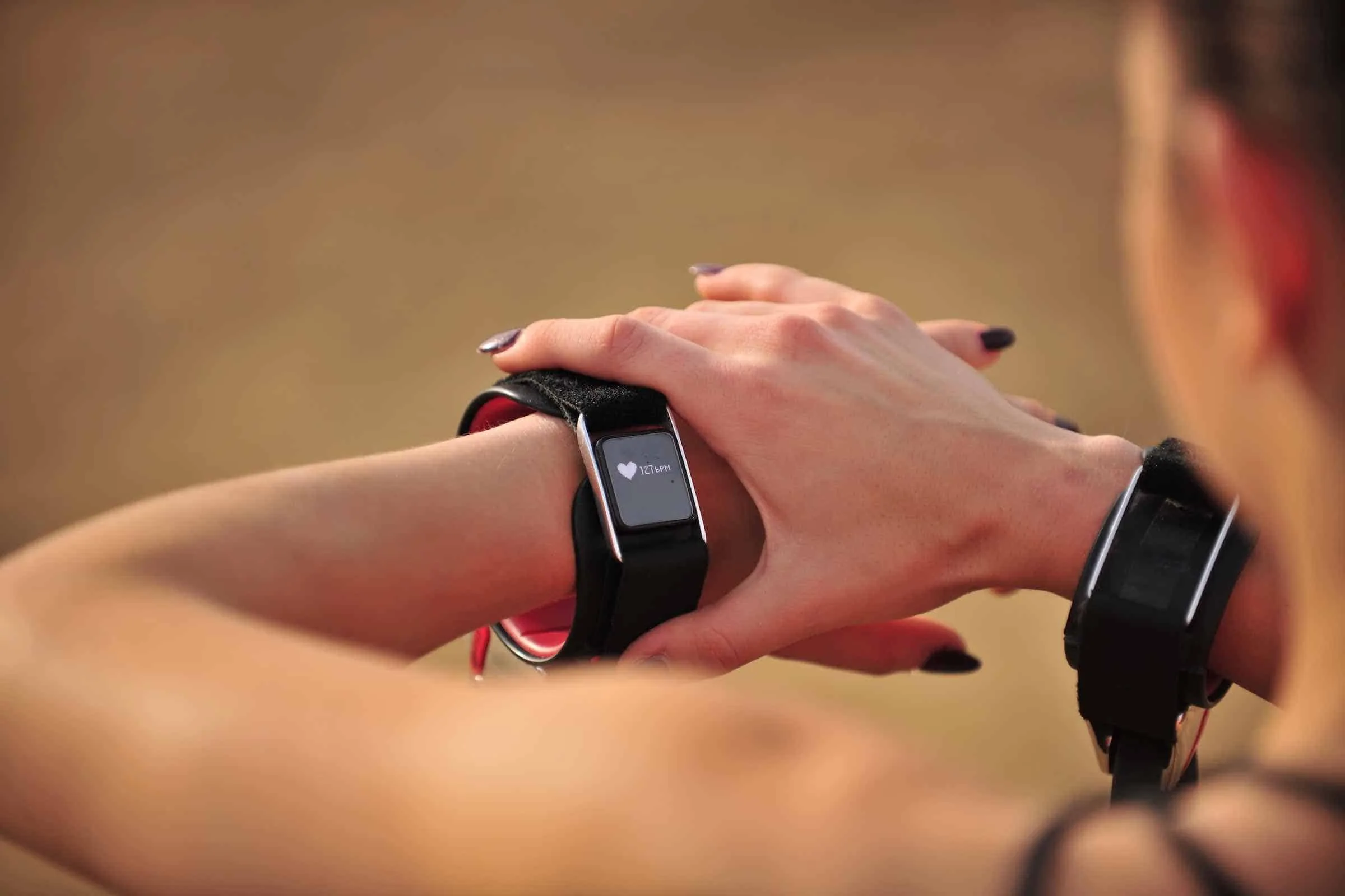 Person checking fitness watch display along Venice Beach